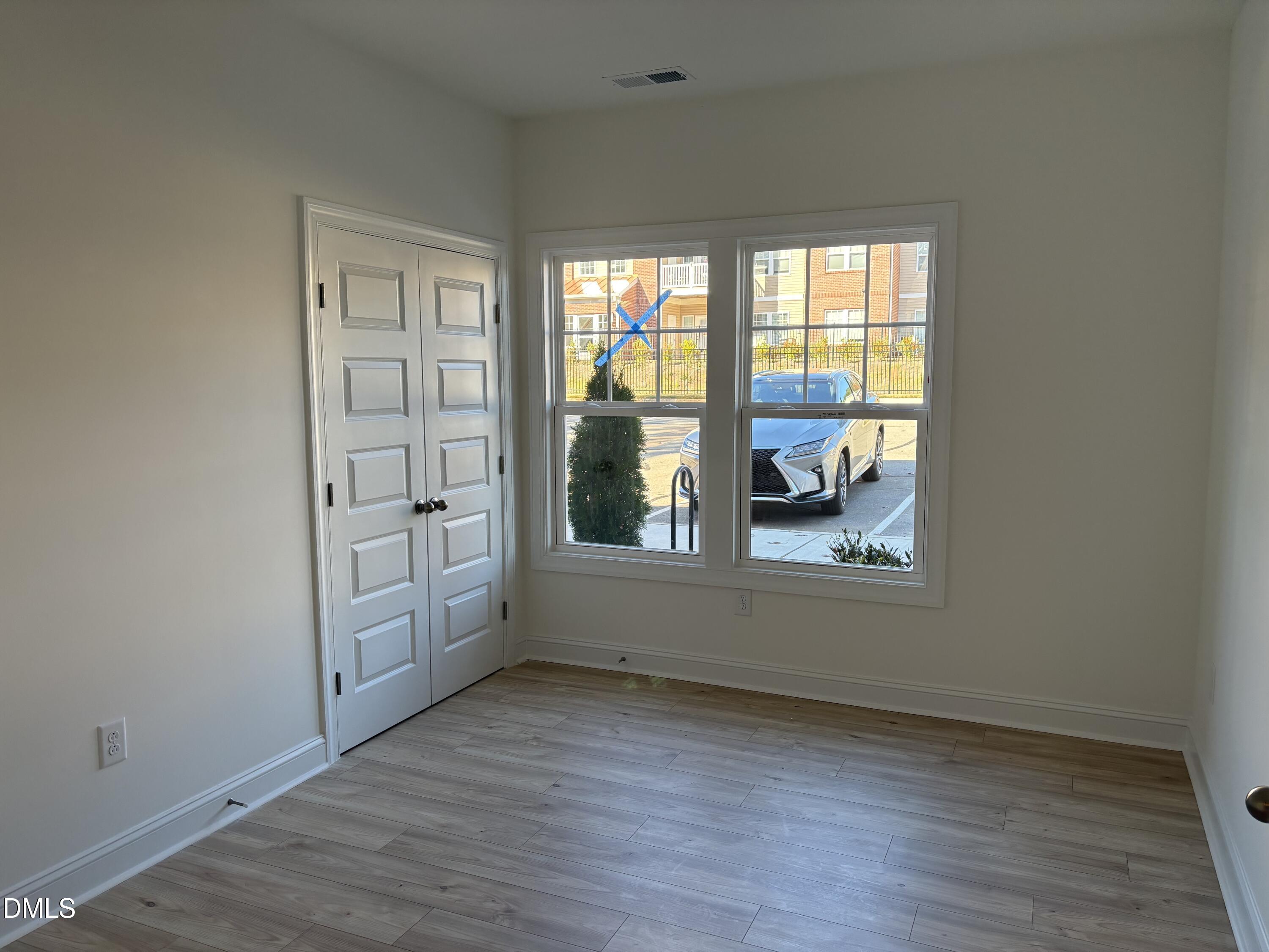 618 Weather Ridge Lane, Unit 28 Cary, NC 27513 - Photo 18 of 27 an empty room with wooden floor and windows