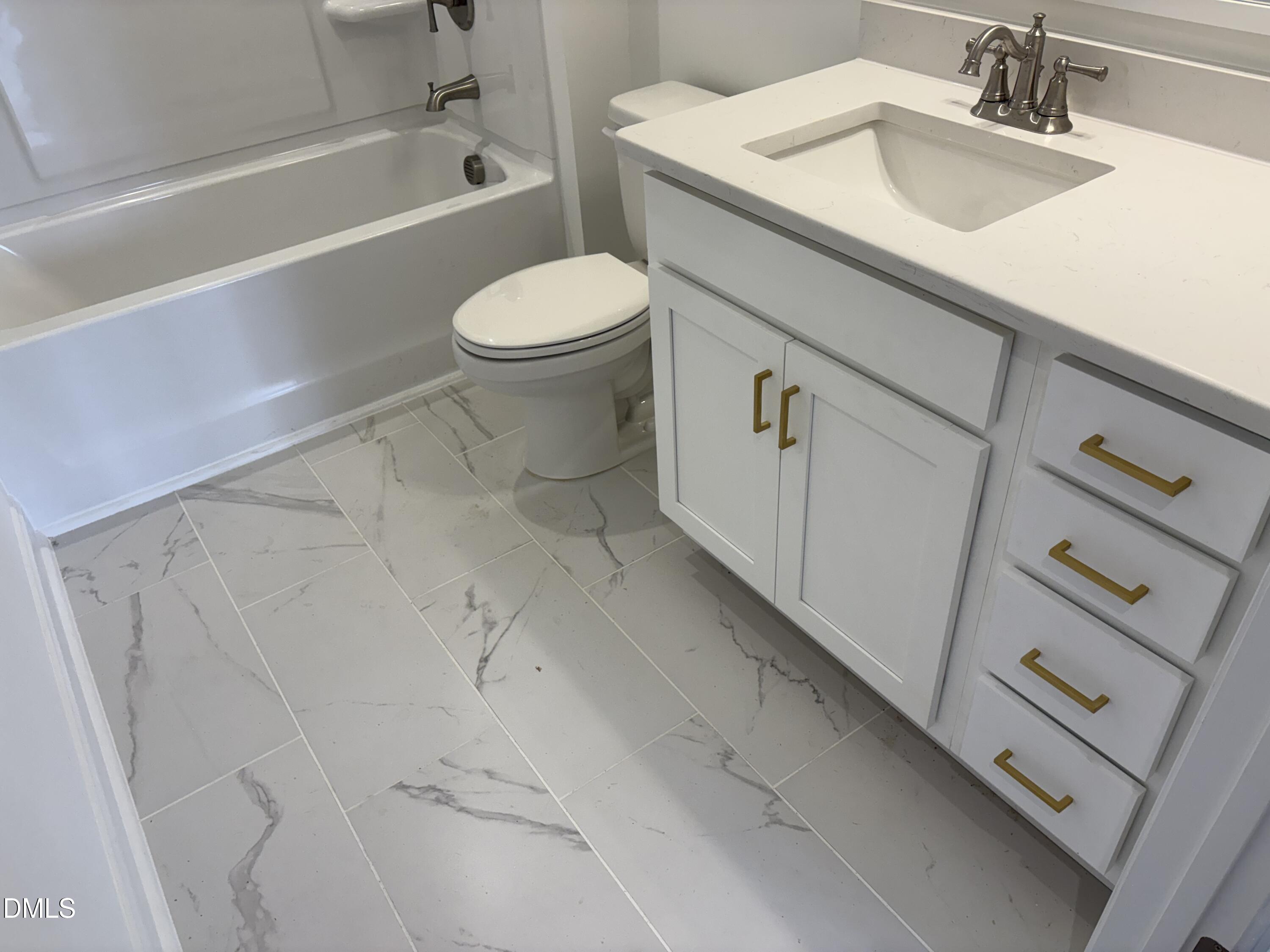 618 Weather Ridge Lane, Unit 28 Cary, NC 27513 - Photo 22 of 27 a bathroom with a sink a toilet and bathtub