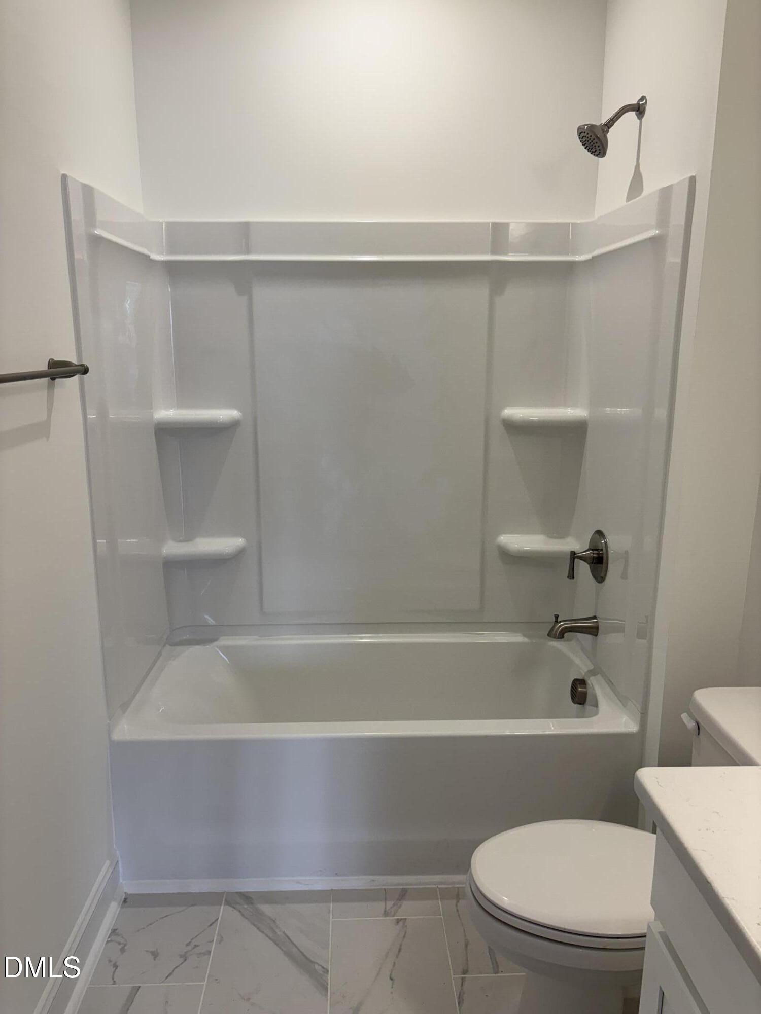 618 Weather Ridge Lane, Unit 28 Cary, NC 27513 - Photo 23 of 27 a bathroom with a toilet and a bath tub