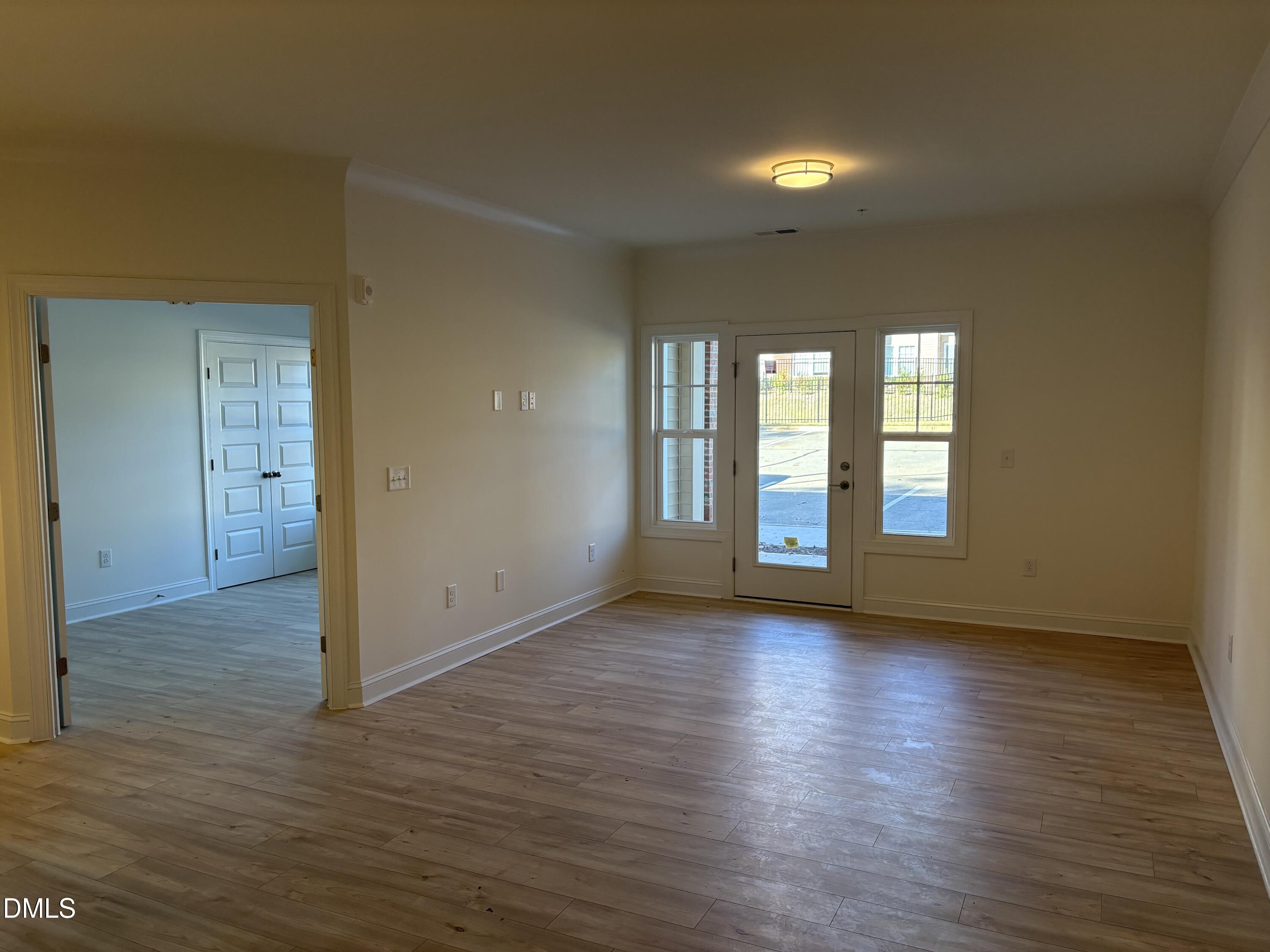 618 Weather Ridge Lane, Unit 28 Cary, NC 27513 - Photo 3 of 27 a view of an empty room with window and wooden floor