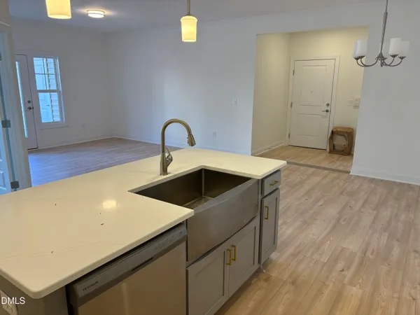 a kitchen that has a sink and a stove in it