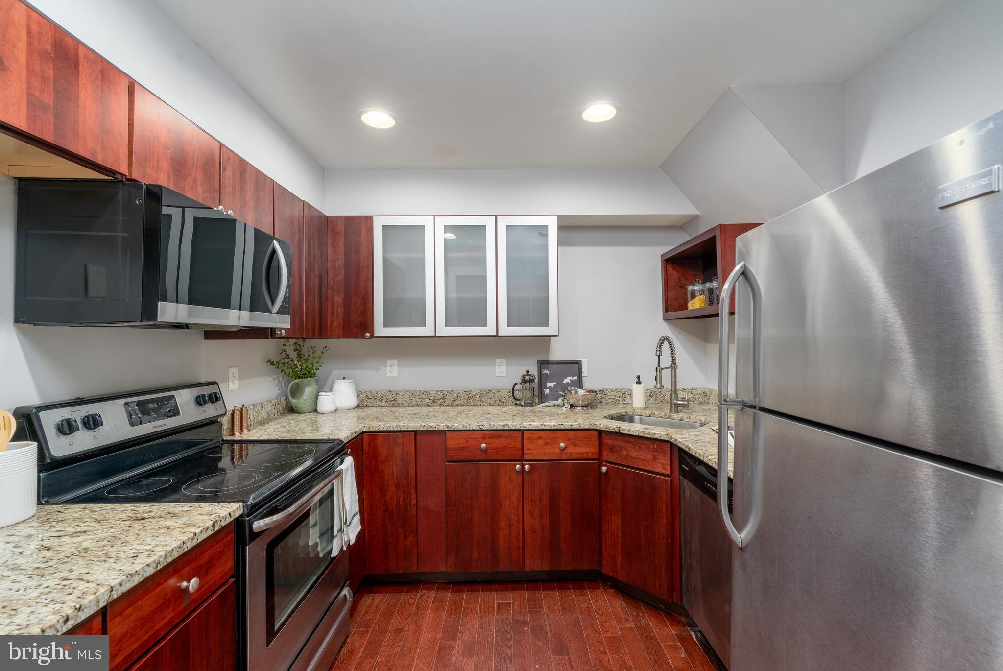 15 West Biddle Street, Unit 15C Baltimore, MD 21201 - Photo 11 of 33 a kitchen with a sink stove and refrigerator