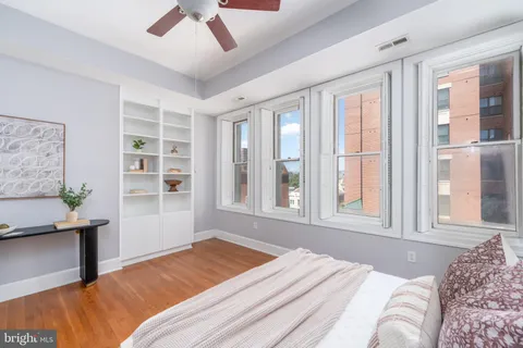 a bedroom with a large bed and a window