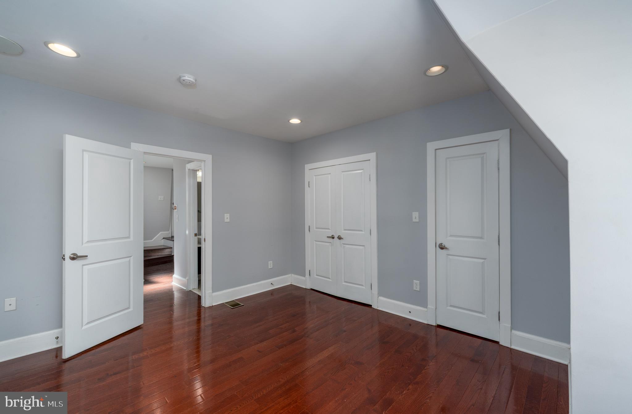 15 West Biddle Street, Unit 15C Baltimore, MD 21201 - Photo 21 of 33 wooden floor in an empty room with wooden floor