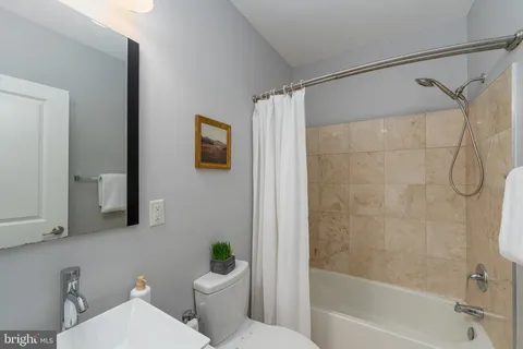 a white toilet sitting next to a bath tub shower
