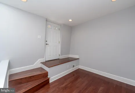 a view of room with wooden floor