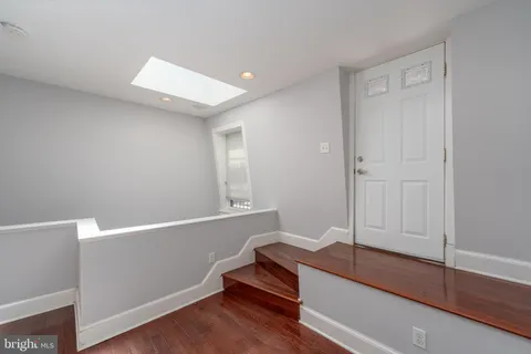 a view of room with wooden floor