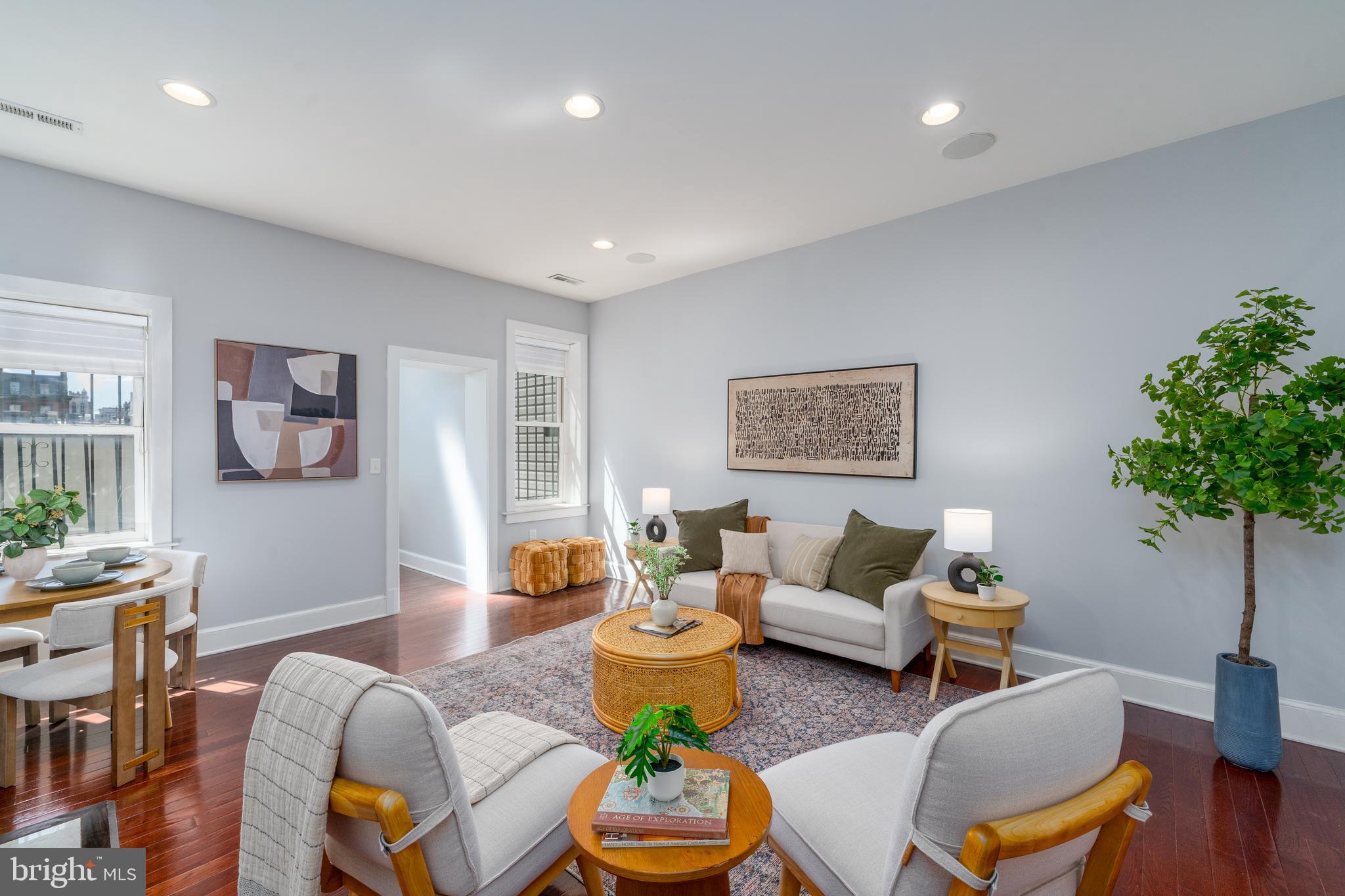 15 West Biddle Street, Unit 15C Baltimore, MD 21201 - Photo 3 of 33 a living room with furniture potted plant and a window