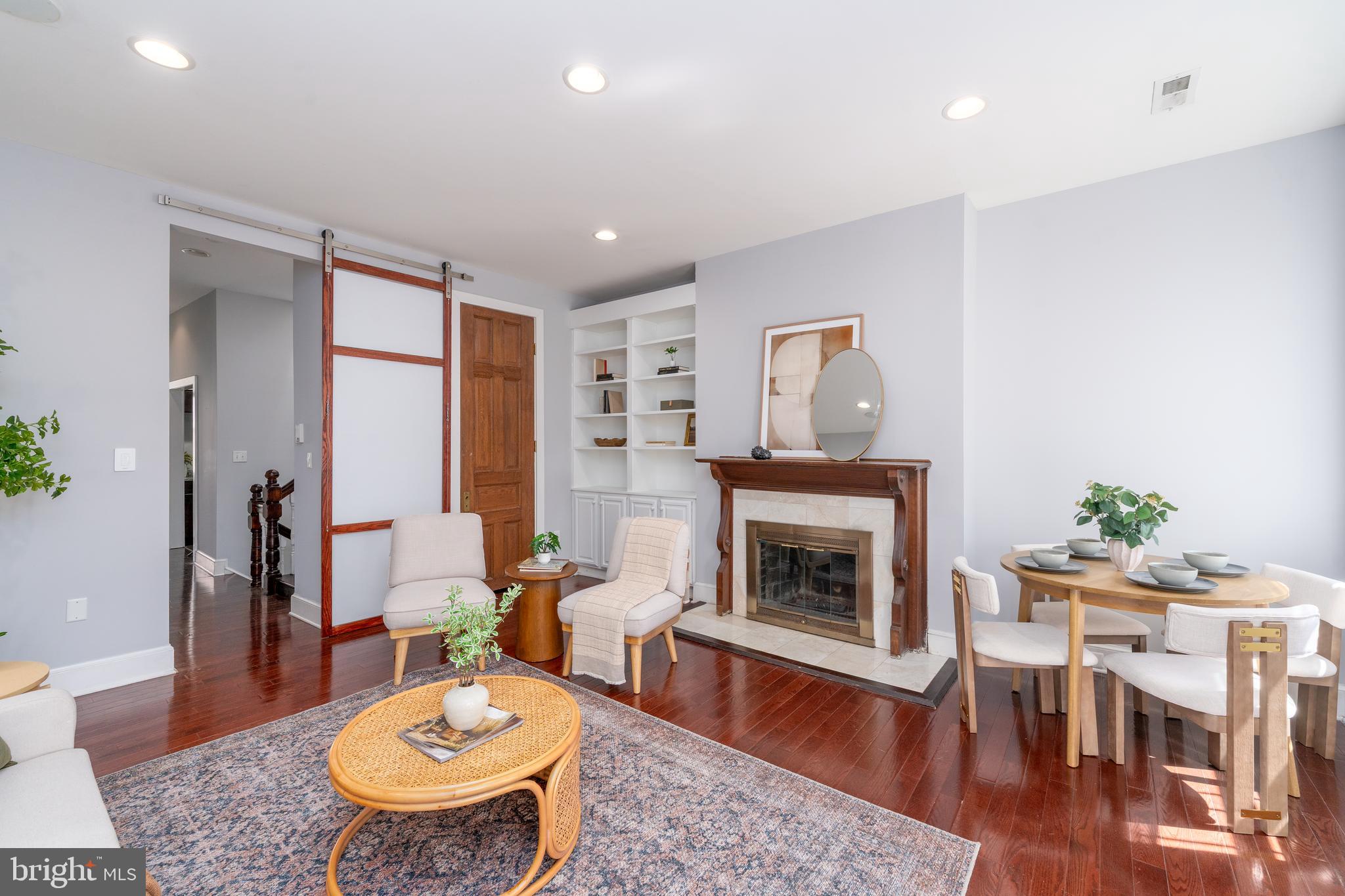 15 West Biddle Street, Unit 15C Baltimore, MD 21201 - Photo 6 of 33 a living room with furniture and a fireplace
