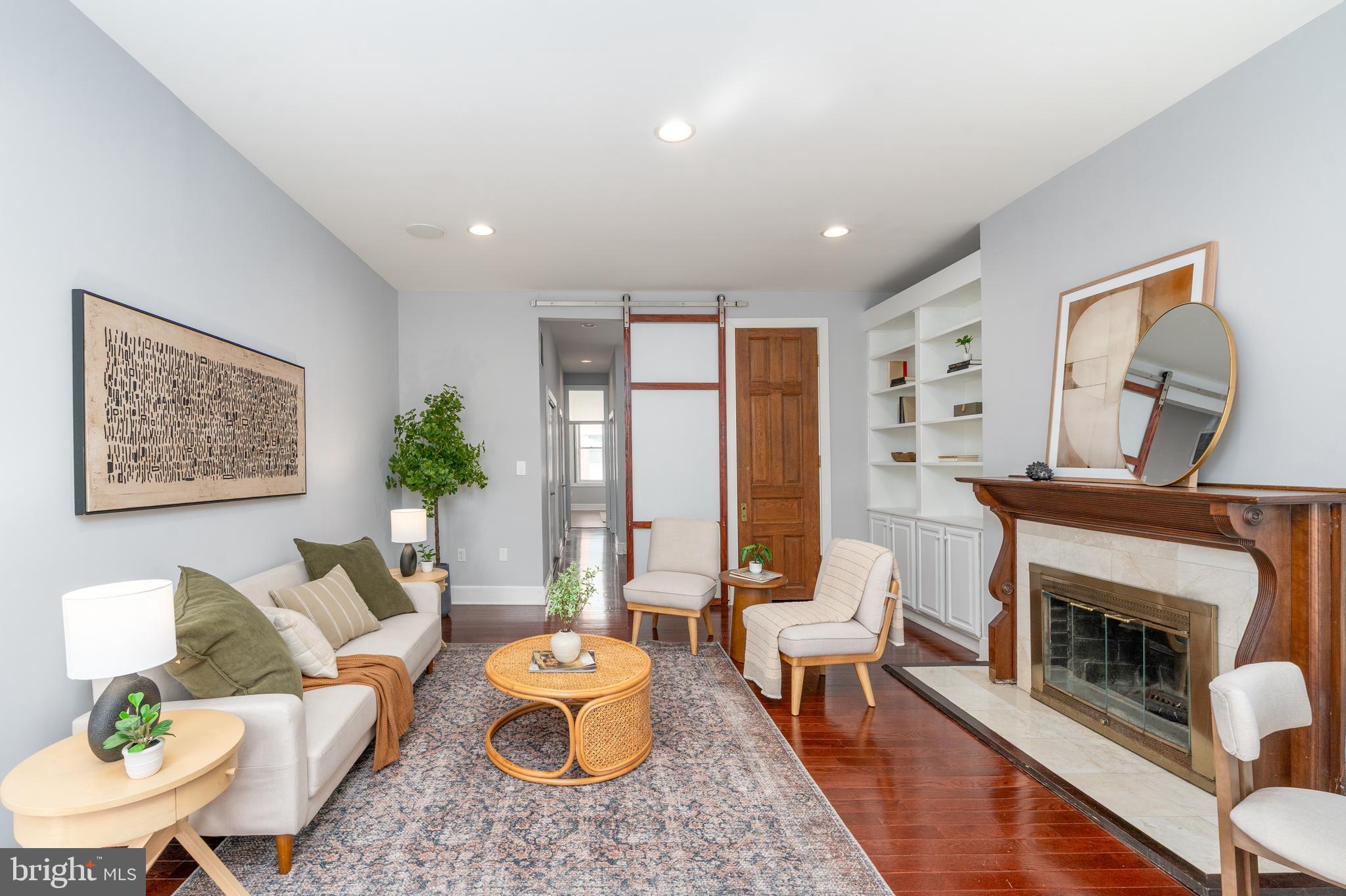 15 West Biddle Street, Unit 15C Baltimore, MD 21201 - Photo 7 of 33 a living room with furniture and a fireplace