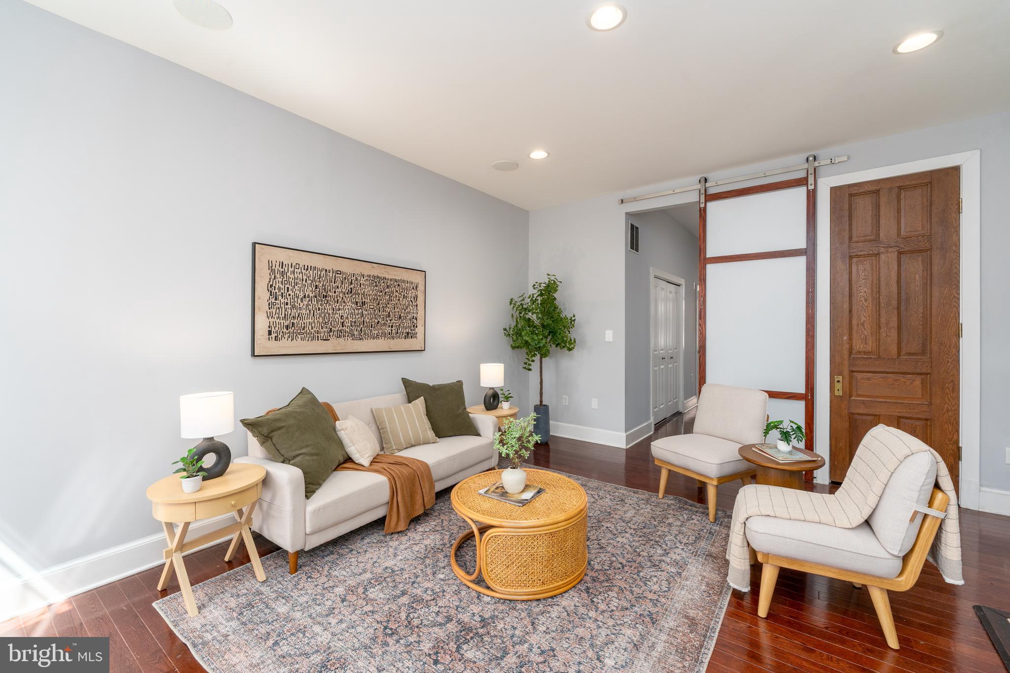 15 West Biddle Street, Unit 15C Baltimore, MD 21201 - Photo 8 of 33 a living room with furniture and a potted plant
