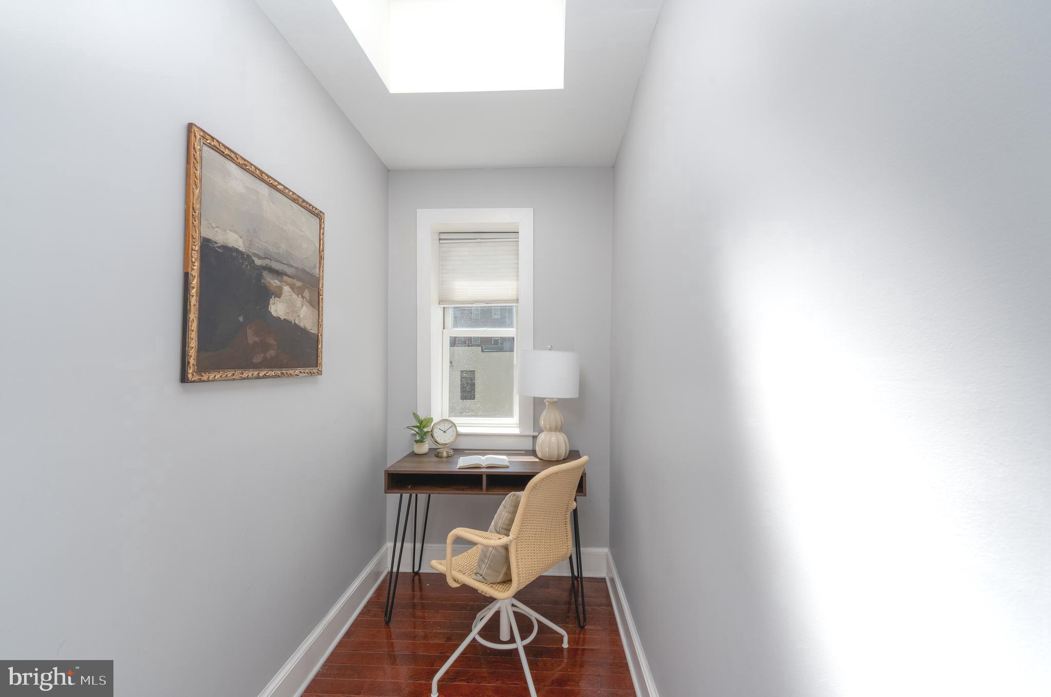 15 West Biddle Street, Unit 15C Baltimore, MD 21201 - Photo 9 of 33 a view of a room that has a table and chair