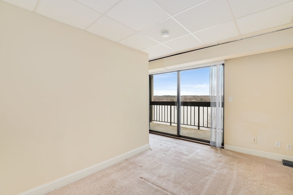 1500 Worcester Road, Unit 710 Framingham, MA 01702 - Photo 15 of 33 an empty room with sliding door