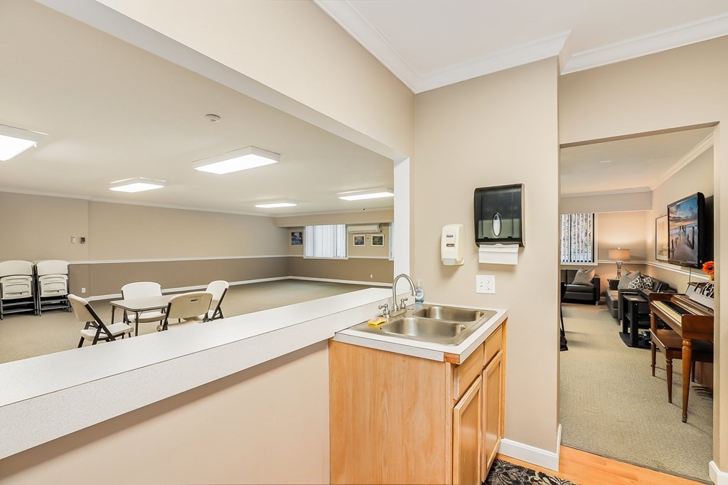 1500 Worcester Road, Unit 710 Framingham, MA 01702 - Photo 25 of 33 a kitchen with a sink appliances and a counter top space
