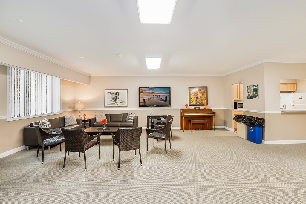 1500 Worcester Road, Unit 710 Framingham, MA 01702 - Photo 28 of 33 a living room with furniture and a flat screen tv