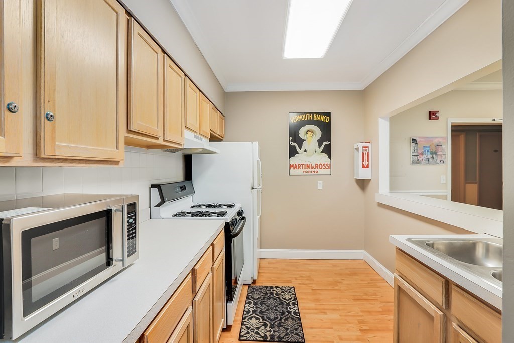 1500 Worcester Road, Unit 710 Framingham, MA 01702 - Photo 32 of 33 a kitchen with stainless steel appliances granite countertop a stove and a sink
