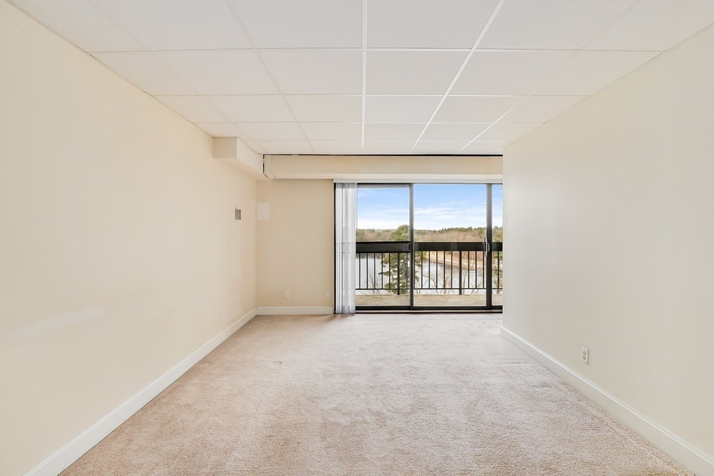 1500 Worcester Road, Unit 710 Framingham, MA 01702 - Photo 4 of 33 an empty room with windows