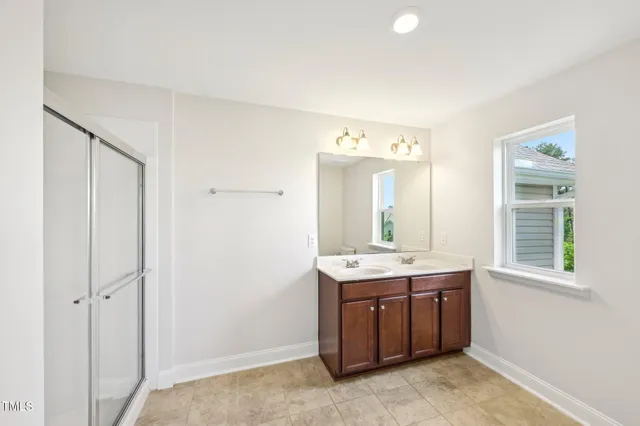 a room with a sink vanity and mirror