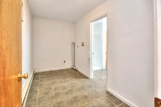 a bathroom with a sink shower and a mirror
