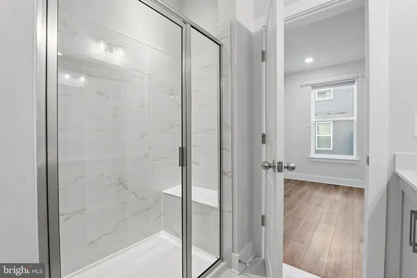 a bathroom with a glass shower door