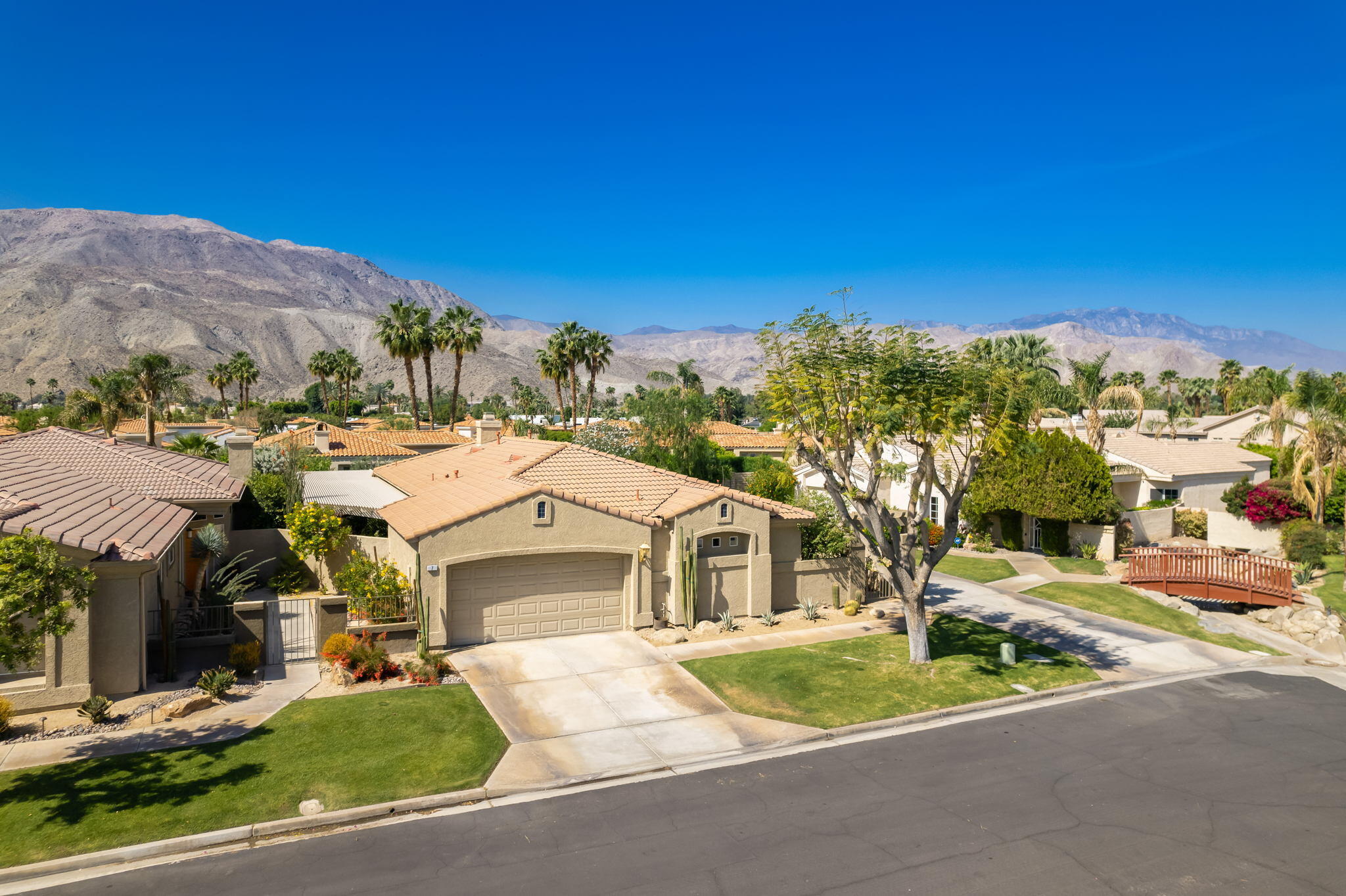 7 Florentina Drive Rancho Mirage, CA 92270 - Photo 2 of 7 a front view of a house with a yard and garage