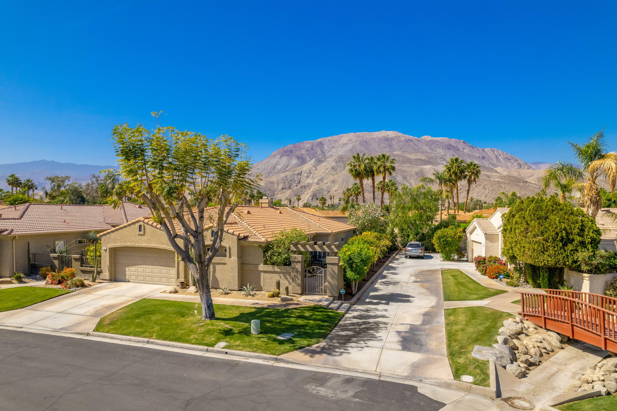 7 Florentina Drive Rancho Mirage, CA 92270 - Photo 4 of 7 a front view of a house with a yard and trees