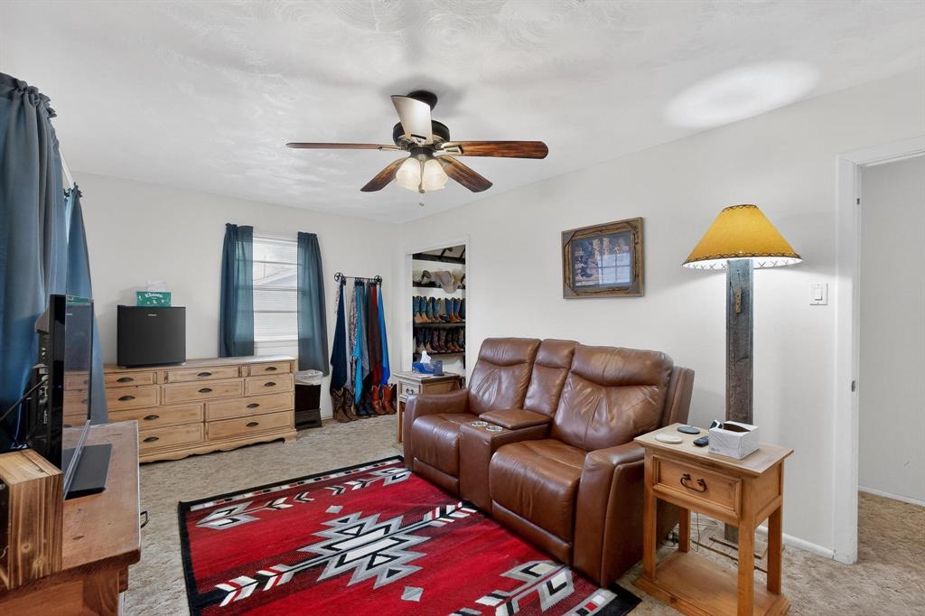 202 Senter Valley Road Irving, TX 75060 - Photo 15 of 32 Carpeted room featuring a ceiling fan with light fixture, window with blinds, and white walls