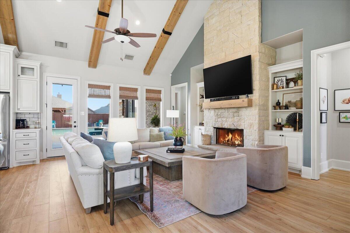 1202 North 14th Place Wolfforth, TX 79382 - Photo 14 of 75 a living room with fireplace furniture and a flat screen tv