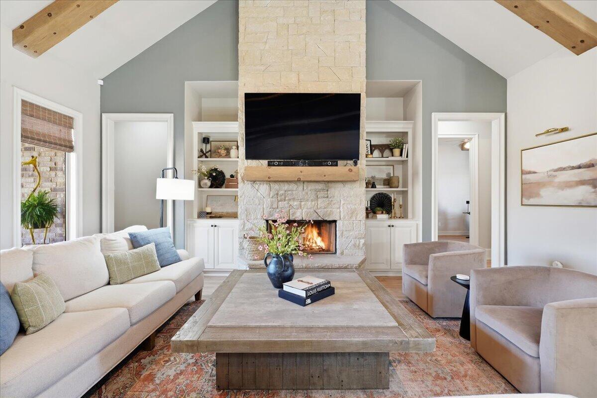 1202 North 14th Place Wolfforth, TX 79382 - Photo 15 of 75 a living room with furniture a flat screen tv and a fireplace