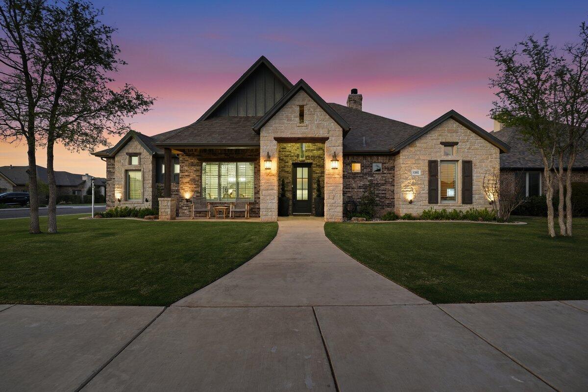 1202 North 14th Place Wolfforth, TX 79382 - Photo 2 of 75 a front view of a house with a garden and yard