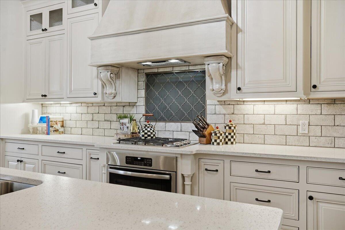 1202 North 14th Place Wolfforth, TX 79382 - Photo 22 of 75 a kitchen with stainless steel appliances granite countertop a stove and cabinets