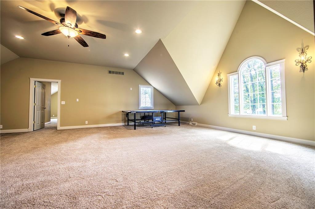 118 Klein Road Cranberry Township, PA 16066 - Photo 18 of 25 28x27 Upper level loft with pitched ceiling, new carpeting, ceiling fan/light, recessed lighting, sconces and wood trim.