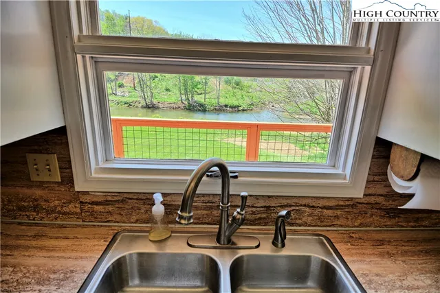 a kitchen with a sink a stove and a window