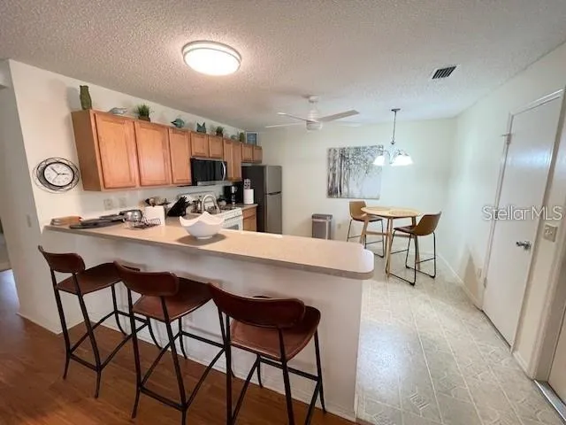 a kitchen with stainless steel appliances kitchen island granite countertop a sink and cabinets