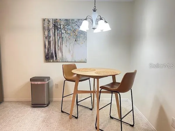 a view of a dining room with furniture and chandelier