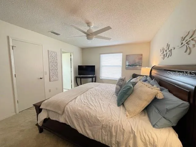 a bedroom with a bed and a television