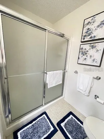 a bathroom with a glass shower door