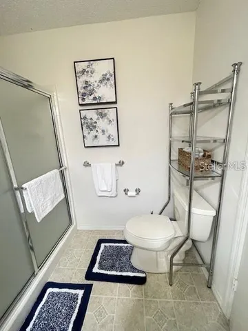 a bathroom with a toilet a sink and a mirror