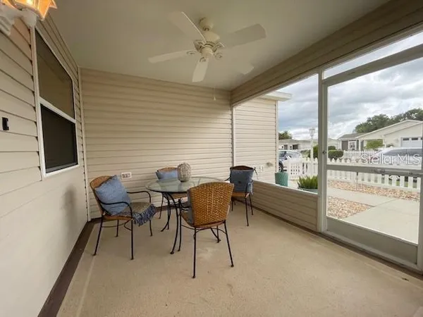 a dining room with furniture and a flat screen tv