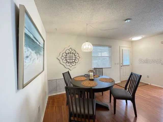 a view of a dining room with furniture and wooden floor