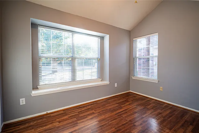a view of room with window and hardwood floor
