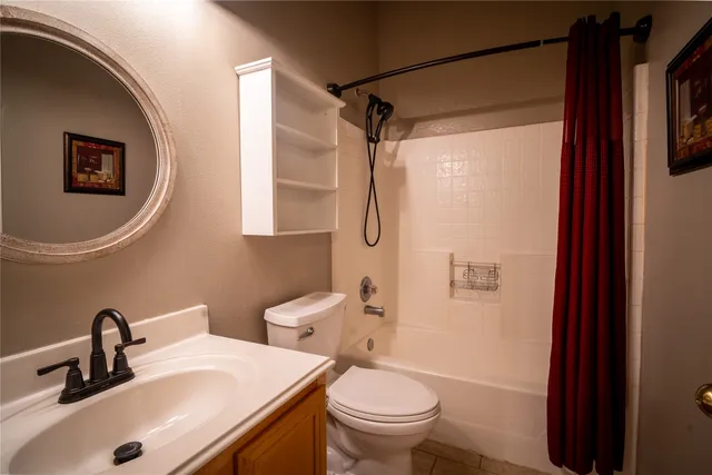 a view of an empty room with wooden floor and closet