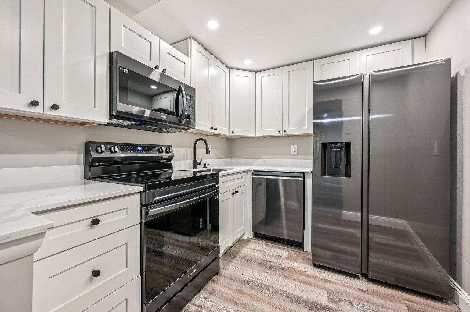 a kitchen with a refrigerator stove and microwave