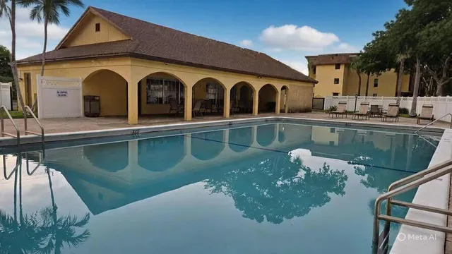 a view of a house with swimming pool next to a yard