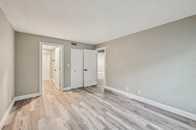 a view of an empty room and wooden floor