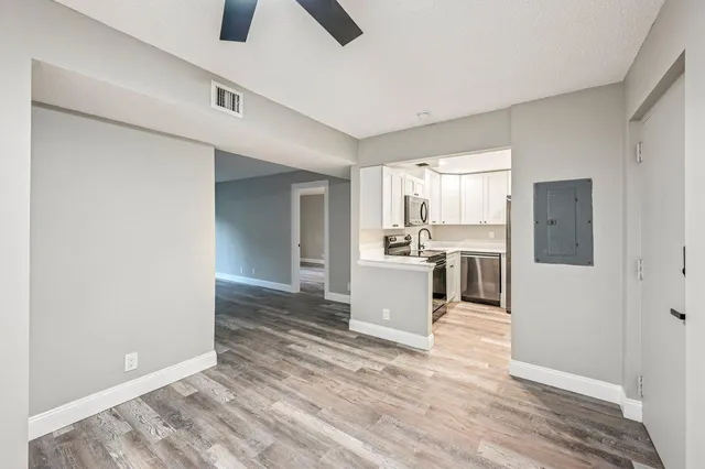 a view of a kitchen with wooden floor