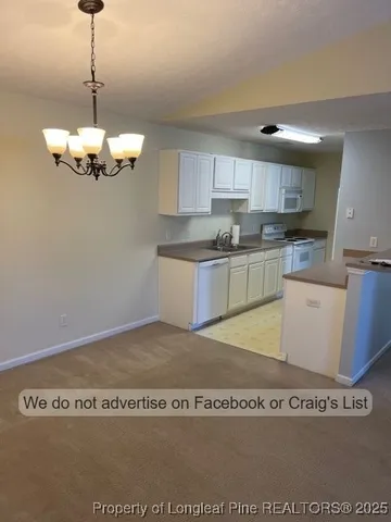 a kitchen with kitchen island granite countertop cabinets and refrigerator