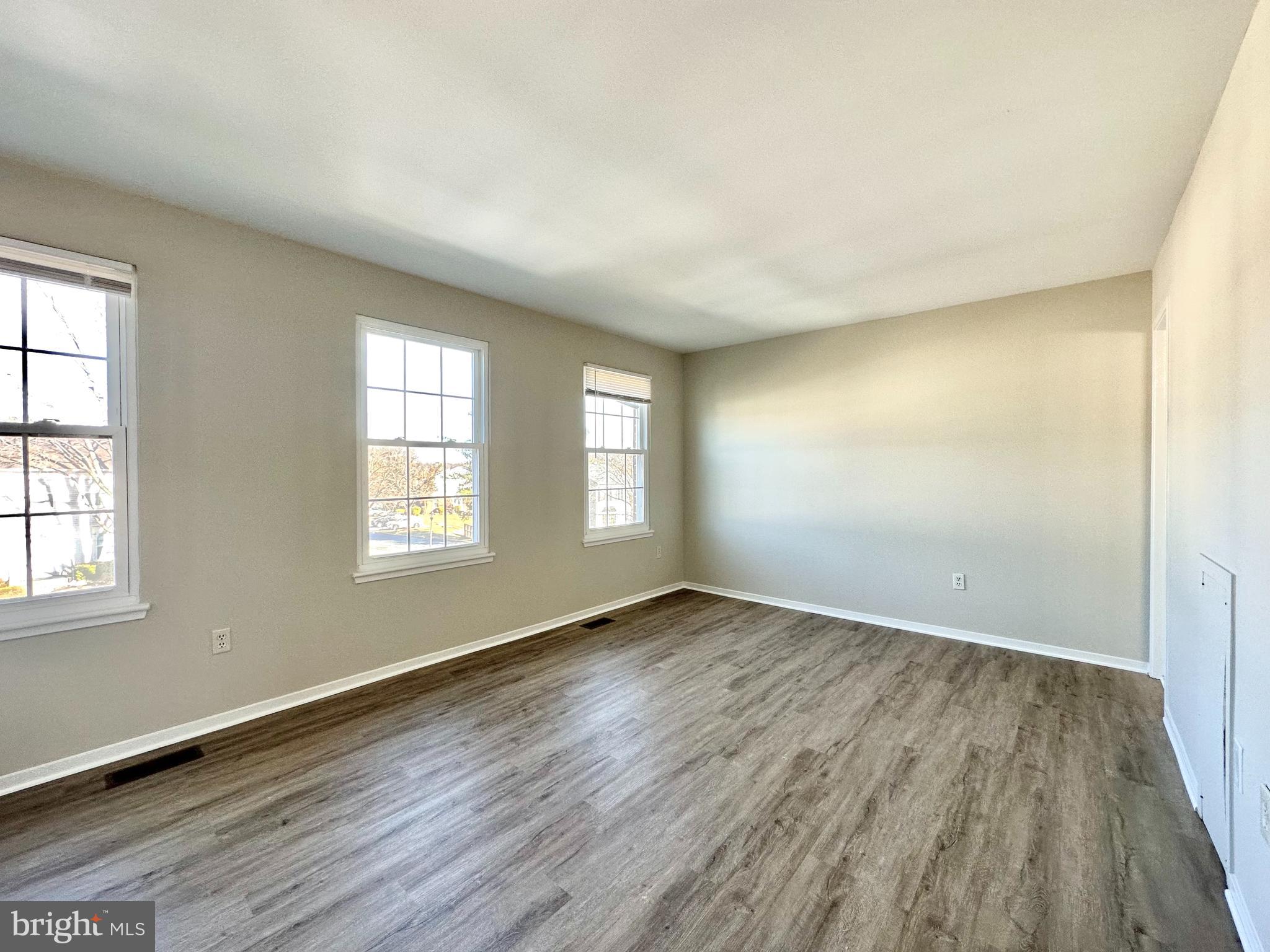 402 Carousel Court Gaithersburg, MD 20877 - Photo 16 of 29 an empty room with wooden floor and windows