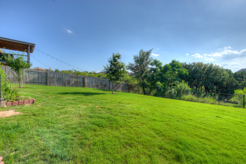 403 Limestone Trail Austin, TX 78737 - Photo 17 of 18 A spacious, verdant yard awaits outdoor enjoyment with ample room for recreation.