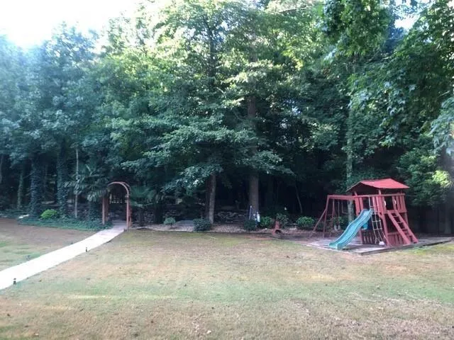 a wooden house with tall trees